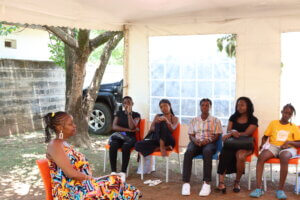 Training session under a tent with participants facing the facilitator