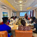 A CONFERENCE ROOM WITH HEALTH CARE PROVIDERS UNDERGOING A TRAINIGN ON GENDER AND SEXUAL DIVERSITY