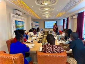 A CONFERENCE ROOM WITH HEALTH CARE PROVIDERS UNDERGOING A TRAINIGN ON GENDER AND SEXUAL DIVERSITY